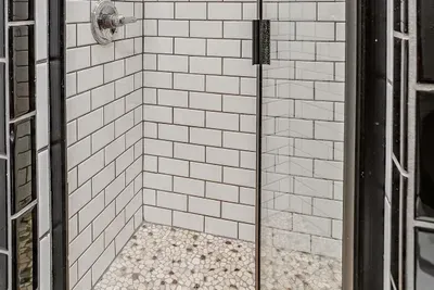 Bright and modern walk-in shower with sleek finishes and practical design elements