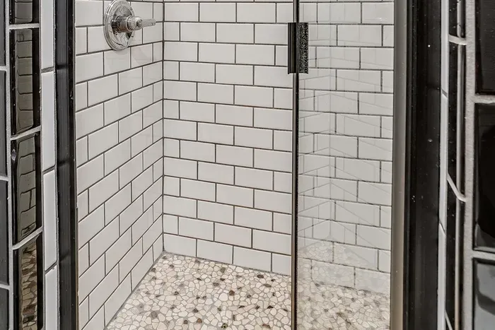 Bright and modern walk-in shower with sleek finishes and practical design elements