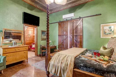 Rest in ultimate comfort on a luxurious California king bed with a charming four-post frame