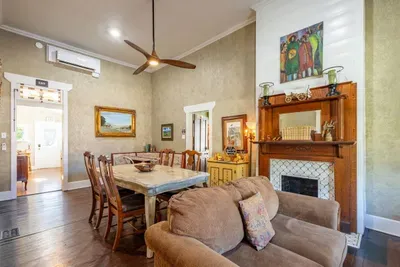 This combined dining area and living room creates a welcoming space for guests to gather. The comfortable seating and dining table provide a great spot to enjoy meals, play games, or spend time with loved ones.