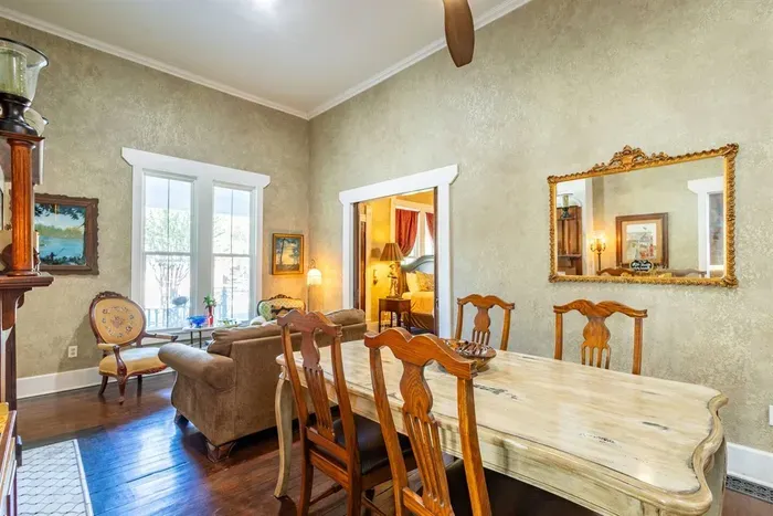 This combined dining area and living room creates a welcoming space for guests to gather. The comfortable seating and dining table provide a great spot to enjoy meals, play games, or spend time with loved ones.