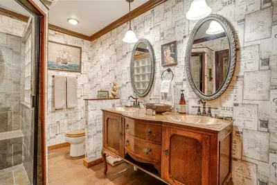 Luxurious ensuite bathroom featuring dual copper sinks, high-end toiletries, and stylish decor