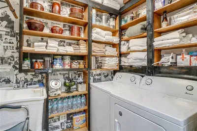 Conveniently equipped laundry room with ample storage for guest needs