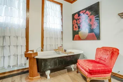Original clawfoot tub provides a perfect space for a relaxing bubble bath