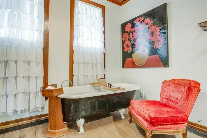 Original clawfoot tub provides a perfect space for a relaxing bubble bath