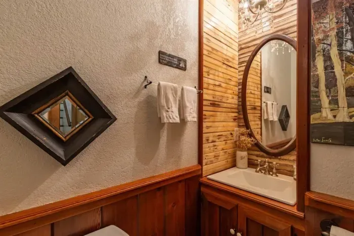 Half bath in the common area, featuring stylish decor and modern amenities