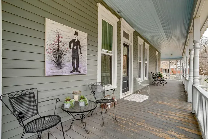 Side porch featuring cozy seating and picturesque views of the surrounding greenery