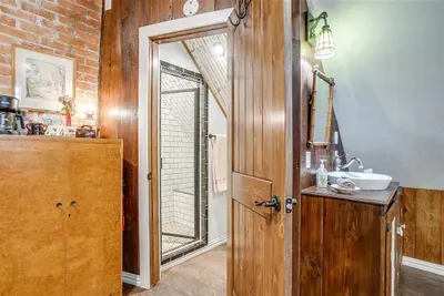 Spacious ensuite bathroom with a walk-in shower and wood-paneled accents for added charm