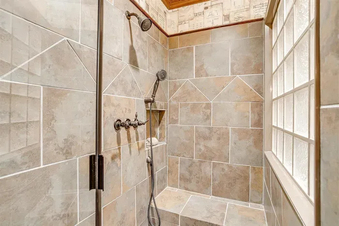 Modern walk-in shower with sleek finishes, providing a refreshing and luxurious bathing experience