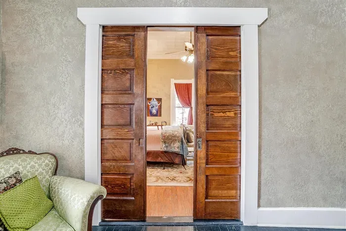 Beautifully restored pocket doors from the 1800s add historic charm and elegance