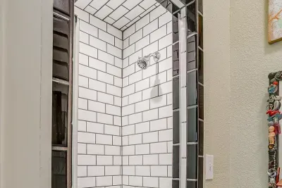 Unique mosaic tile accents in the spacious walk-in shower, blending style and practicality