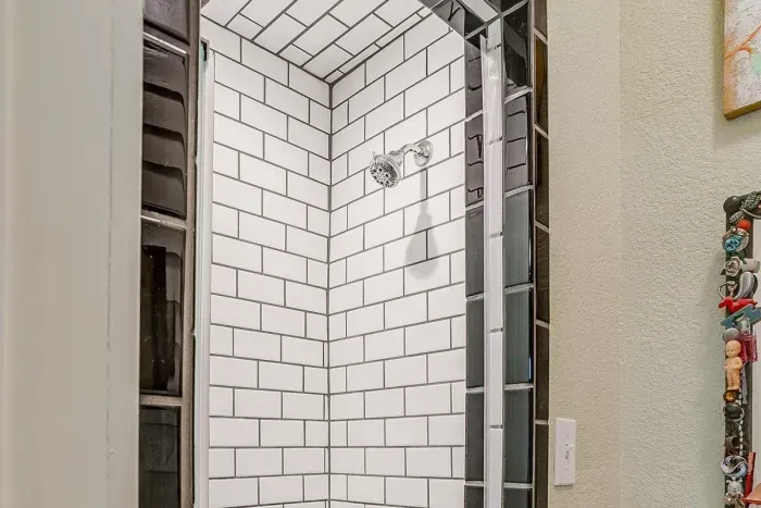Unique mosaic tile accents in the spacious walk-in shower, blending style and practicality