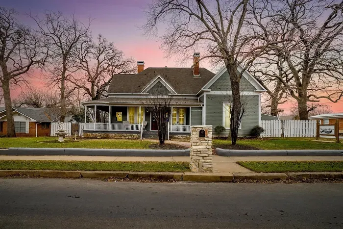 The beautifully restored Gallery House showcases its timeless architecture and inviting front porch