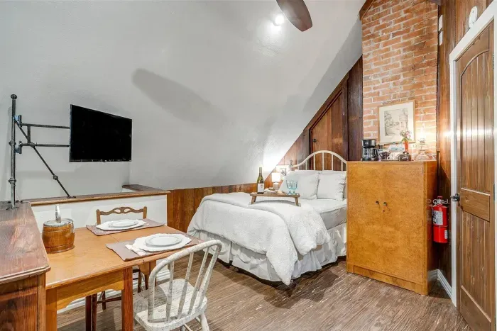 Cozy loft area with a full bed, smart TV, and comfortable seating for a relaxing experience