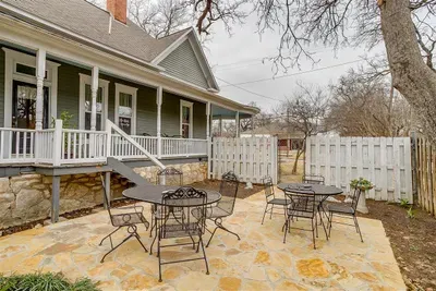 Spacious rock patio surrounded by trees, providing a serene outdoor retreat