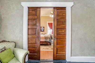 Beautifully restored pocket doors from the 1800s add historic charm and elegance to the space