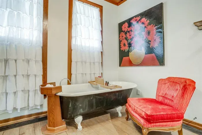 Original clawfoot tub provides a perfect space for a relaxing bubble bath, blending historic charm with luxury