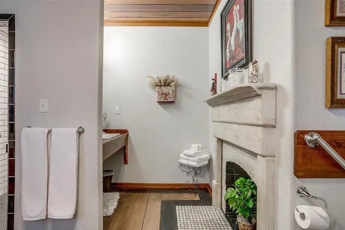 Unique bathroom featuring an original fireplace, adding warmth and character to the space