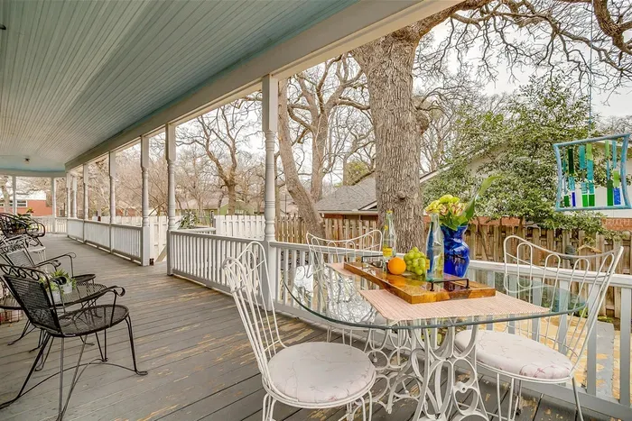 Relax on the wrap-around porch with cozy seating, offering a peaceful outdoor space to enjoy your surroundings