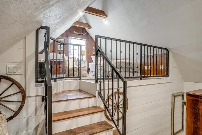 The unique two-level design features a small set of stairs separating the space while keeping it open