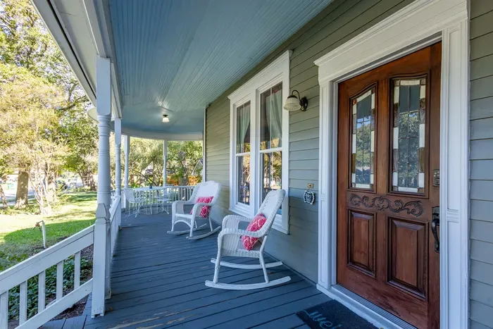 The front patio offers a peaceful outdoor space to sit and relax, with comfortable seating and a view of the lovely surrounding landscape. It’s a charming space to enjoy the morning or evening in a serene atmosphere.