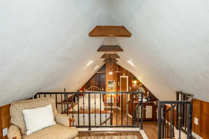 The loft offers a quiet retreat with comfortable seating and a unique two-level design