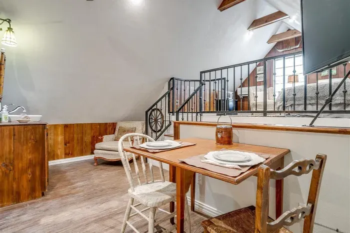 Well-designed loft area with a table and seating, ideal for meals or relaxing