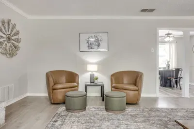 A quieter corner of the living room with two swivel chairs, off to the side of the main sectional.
