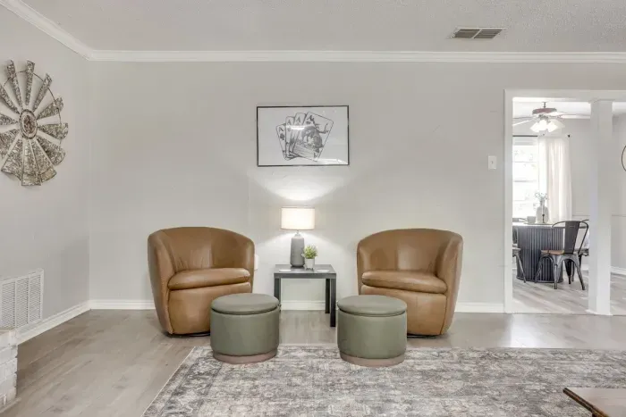 A quieter corner of the living room with two swivel chairs, off to the side of the main sectional.