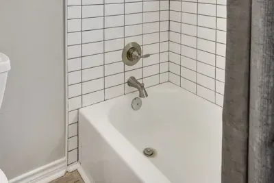 Tub and shower combo with subway tile.