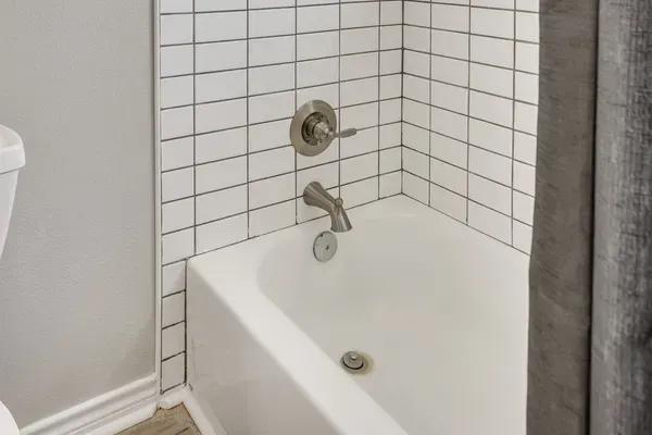 Tub and shower combo with subway tile.