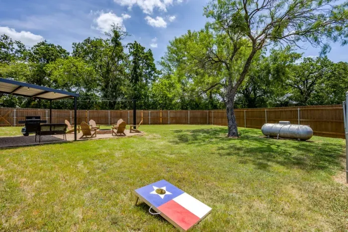 Mature oaks for shade, a gas grill under cover, and room for everybody.