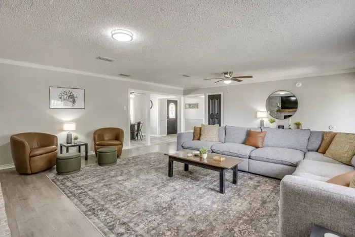 Two leather swivel chairs and a coffee table make a second seating area in the same room.