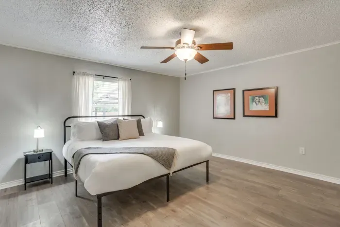 Second king bedroom with a ceiling fan and plenty of natural light.