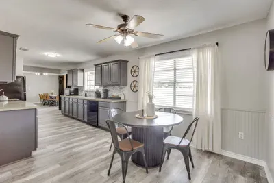 Kitchen and breakfast nook with a round table for coffee, cards, or a laptop. With the main dining table on the other side of the kitchen