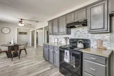 Full electric range and vent hood, with cookware, dishes, and utensils all provided.