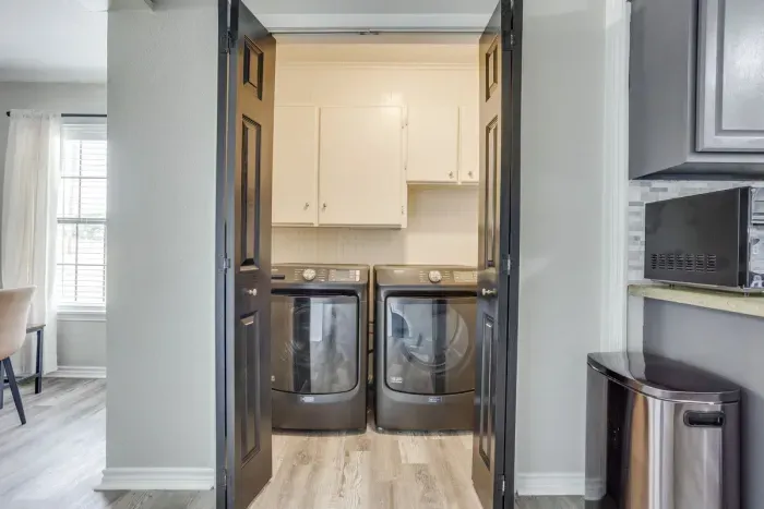 Laundry room right off the kitchen with a full-size washer and dryer.