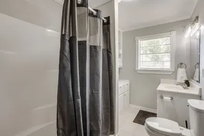Second full bathroom off the hall with a tub and shower combo.