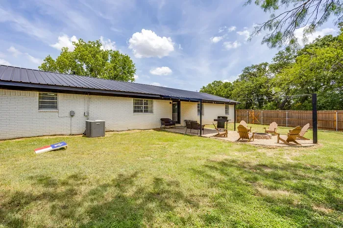 Back door opens right onto the yard, so the grill and the fire pit are a few steps away.