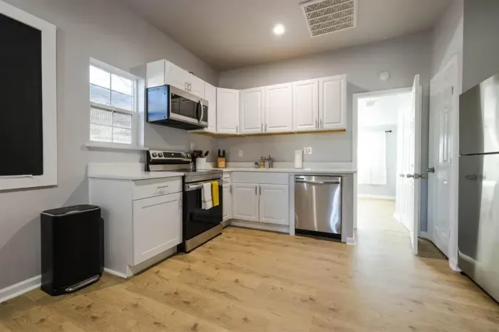 Cook with ease in this spacious kitchen featuring brand-new appliances, sleek countertops, and ample storage space.