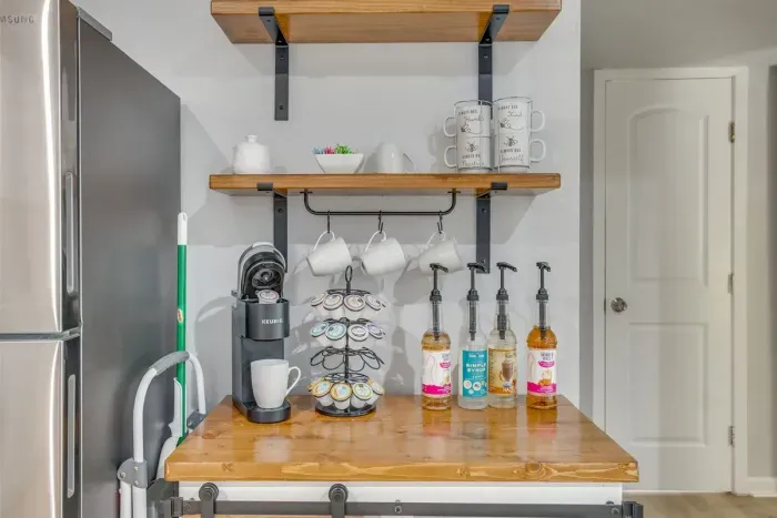 Coffee station stocked and ready — K-cup maker, mugs, syrups, and everything you need to start your morning right without leaving the house.