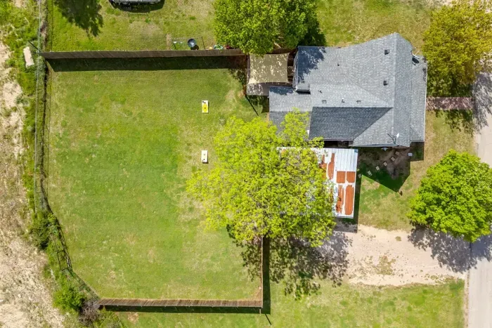 Bird's eye view of The Hive — fully fenced backyard, covered patio, and plenty of green space all on one property.