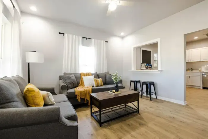 Enjoy this open-concept living room designed for comfort and relaxation, featuring stylish decor and ample seating.