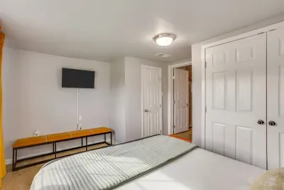 Guest bedroom with queen bed, Smart TV, and its own private closet — everything you need for a comfortable and connected stay.