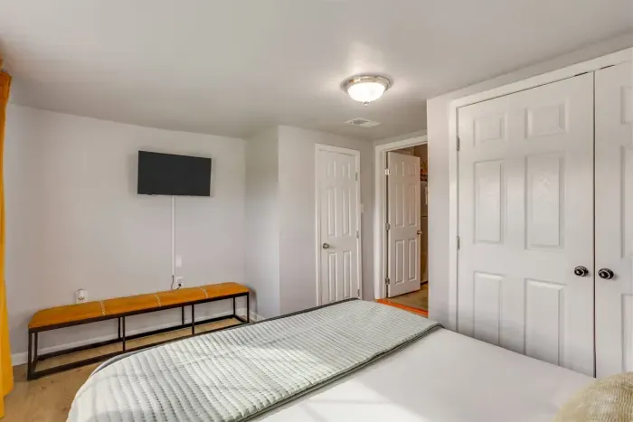 Guest bedroom with queen bed, Smart TV, and its own private closet — everything you need for a comfortable and connected stay.