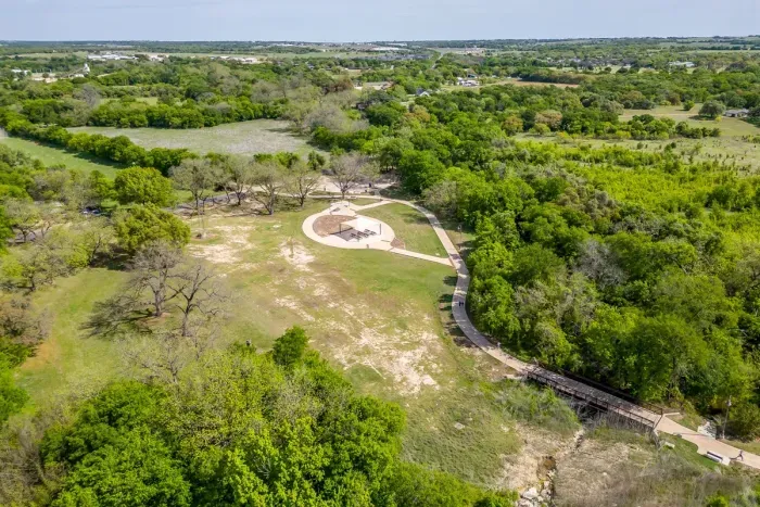 Aerial view of The Hive's backyard backing directly up to the Bosque River Trail and small park