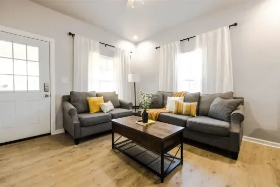 Relax in this inviting living room, complete with cozy seating and abundant natural light. Ideal for gathering with friends and family or enjoying a quiet evening.