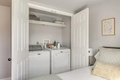 In-unit washer and dryer tucked right inside the bedroom closet — everything you need for longer stays without leaving home.
