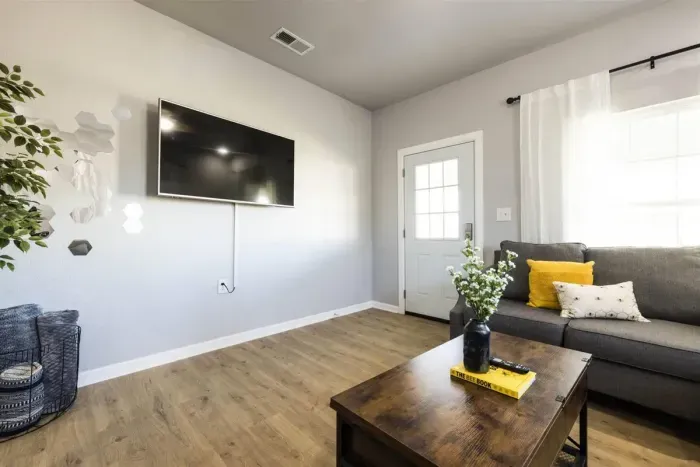 This entertainment-ready living room boasts a large smart TV, perfect for movie nights or catching up on your favorite shows.