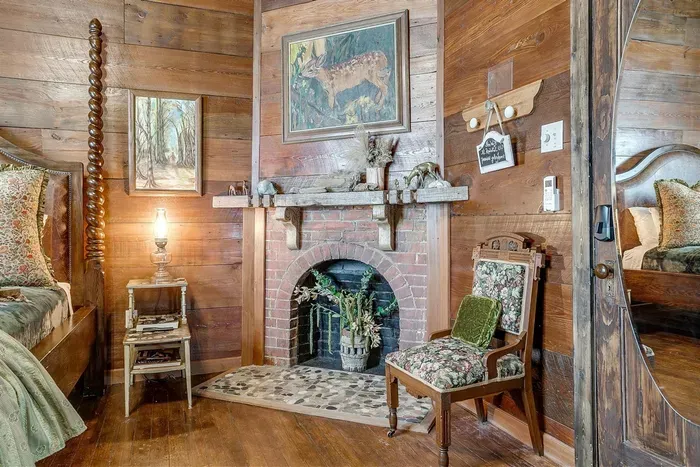 Beautiful original fireplace surrounded by restored shiplap, adding character and warmth to this elegant space